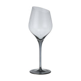 Vrede White Wine Glass, a stemmed glass with an angled slanted rim, smoke-tinted bowl, and long slender stem deepening to a darker grey foot, shown on a plain white background.