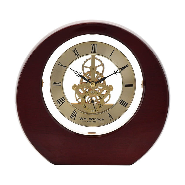 Round mantel clock in mahogany piano gloss wood with gold-tone dial, black Roman numerals, visible skeleton gears, and black hands, set against a plain white background.