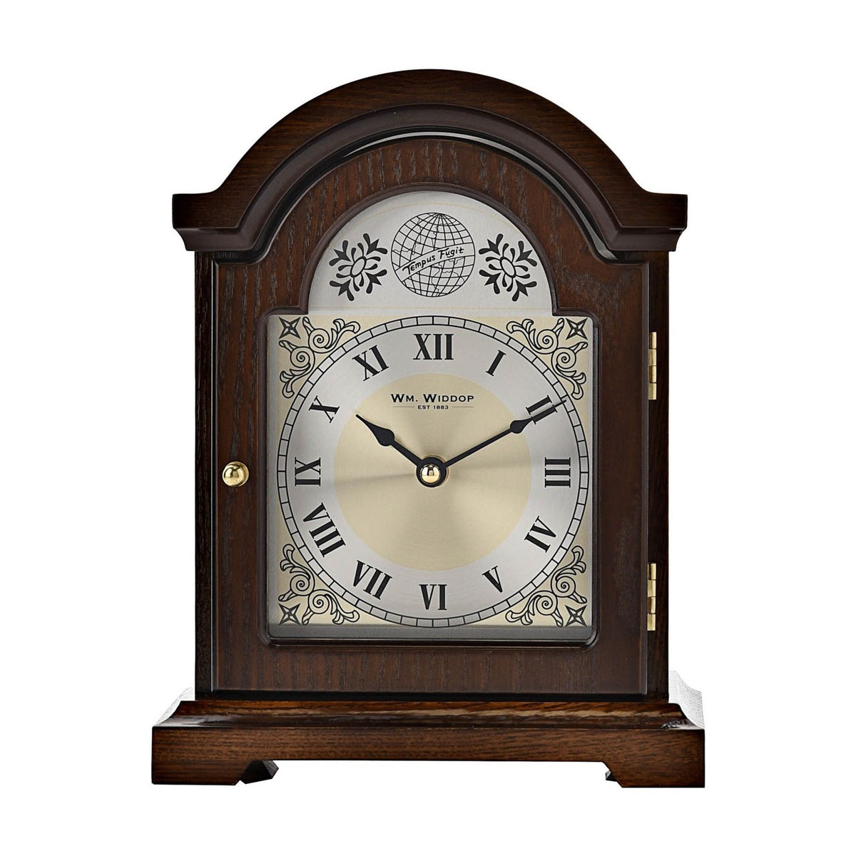 Broken arch wooden mantel clock in walnut finish with silver Roman numeral dial, gold centre, scroll motifs, globe and "Tempus Fugit" text, on a white background.