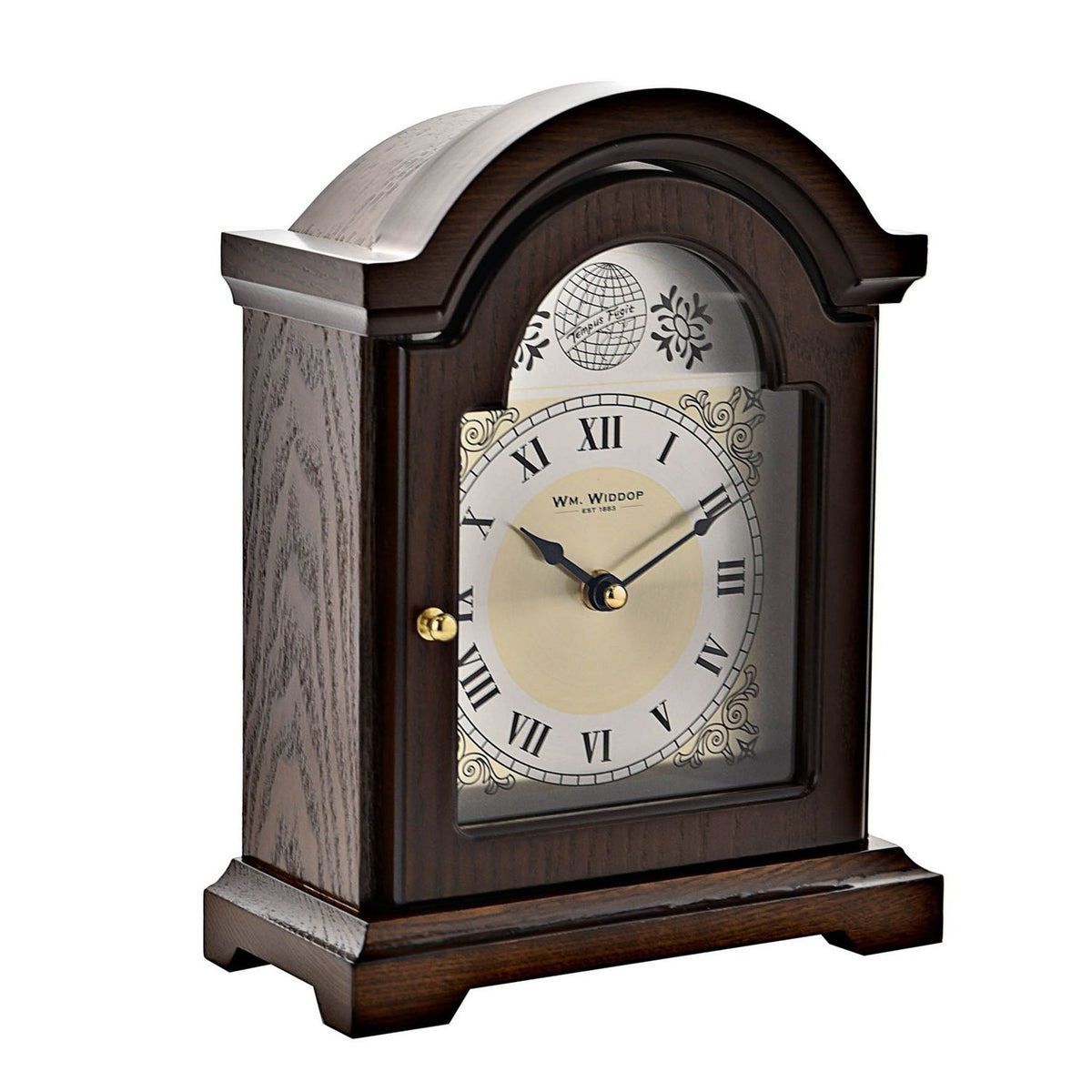 Broken Arch Roman Dial Wooden Mantel Clock in walnut finish, with arched top, "Tempus Fugit" globe motif, silver chapter ring, gold centre, and brass hands on a plain white background.