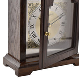 Close-up of the Broken Arch Roman Dial Wooden Mantel Clock in walnut, showing the glazed door, brass knob, Roman numeral dial, and scrolled corner detailing.