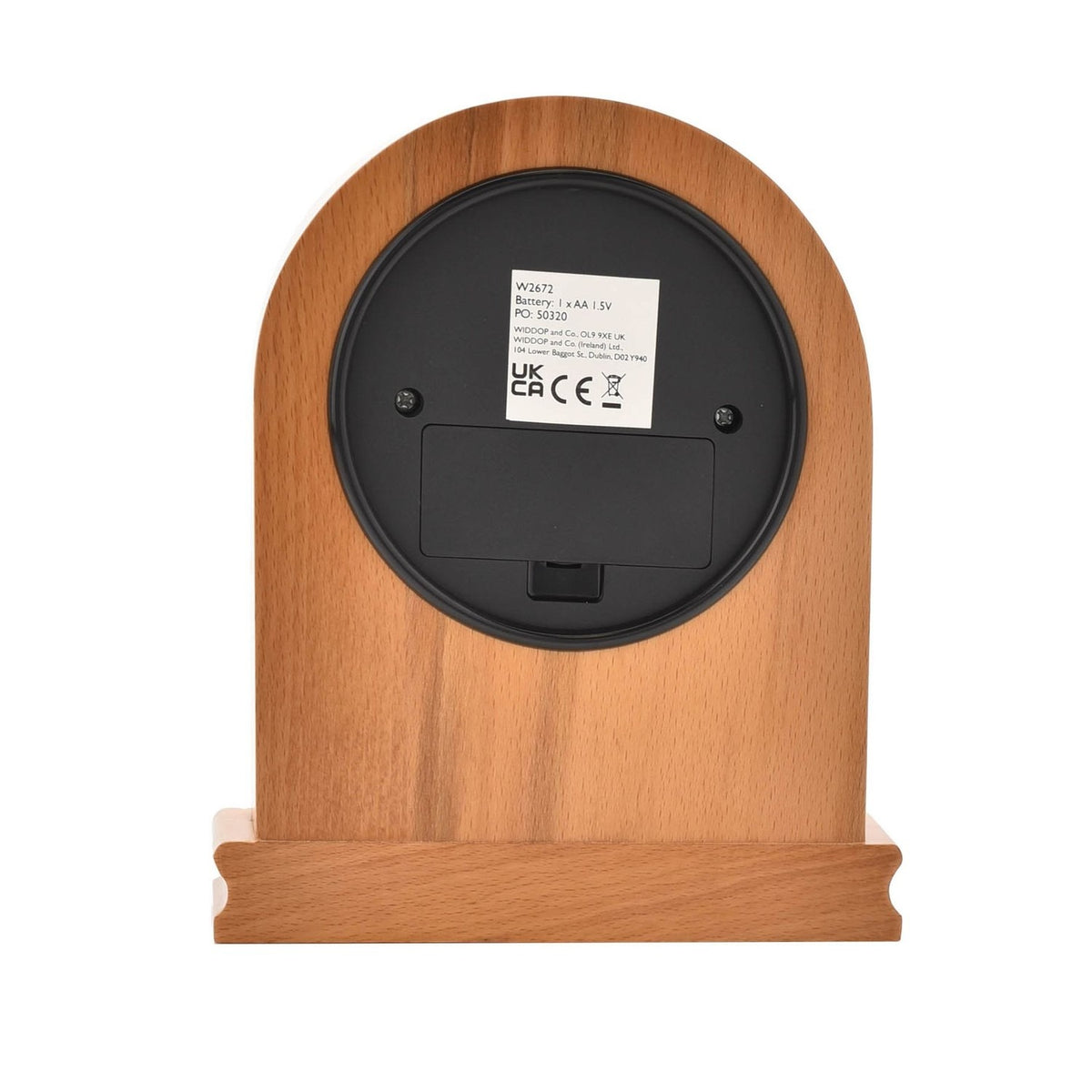 Rear view of the Arched Wooden Mantel Clock in oak, showing the round black battery compartment, mounting screws, and specification label, set on a wooden plinth base against a plain background.