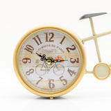 Vintage Bicycle Mantel Clock in gold and cream, round dial with Arabic numerals and bicycle motif set as the rear wheel, distressed finish, shown on a plain white background.