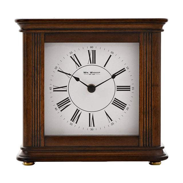 Square Westminster chime mantel clock in walnut effect case with fluted side columns, white dial, black Roman numerals, and spade hands, on a plain white background.