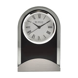 Arched mantel clock with black glass panel and bevelled edge, round silver bezel, Roman numeral dial, and brushed aluminium base, on a plain white background.