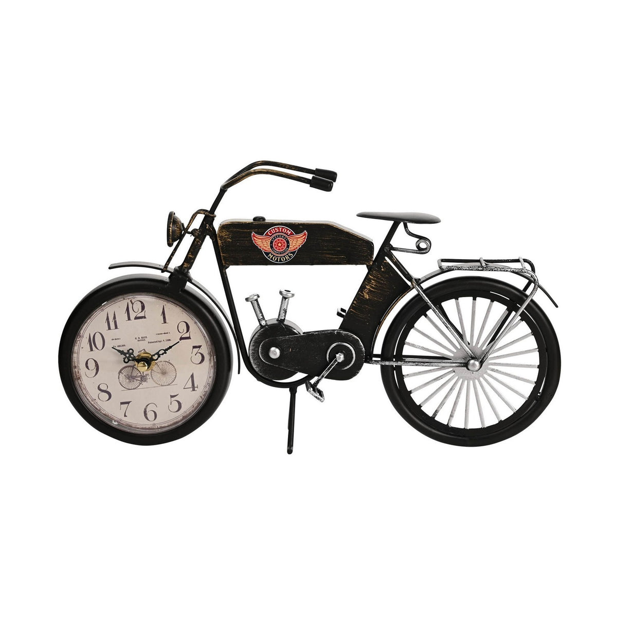 Matt black metal motorcycle-shaped mantel clock with cream Arabic-numeral dial in front wheel, CUSTOM MOTORS fuel tank badge, headlamp, handlebars and spoked rear wheel, on a white background.