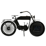 Motorcycle Metal Mantel Clock in matt black with Arabic numeral dial set into the rear wheel, metal frame, seat and kickstand, shown from the reverse side on a white background.