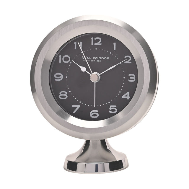 Round mantel alarm clock on a pedestal foot, with a silver casing, black dial, white Arabic numerals, and silver hands, shown on a plain white background.