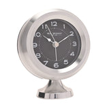 Round mantel alarm clock with silver casing and pedestal foot, black dial with white Arabic numerals and silver hands, shown on a plain white background.