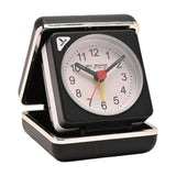 Mini square alarm clock in black folding case with silver trim, white dial, black numerals, black hands, red seconds hand and yellow alarm hand, shown open on a plain white background.