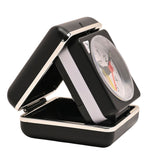 Mini square alarm clock in a black folding case with silver trim, open to show the white dial with black numerals, black hands, red seconds hand and yellow alarm hand, on a plain white background.