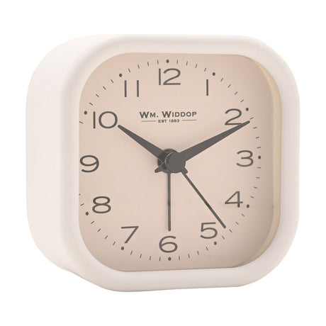 Square metal alarm clock with rounded edges, white case and beige dial, black Arabic numerals and hands, on a plain white background.