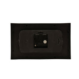 Rear view of the black rectangular mantel clock showing the quartz movement, battery compartment, hanging tab and mounting screw holes on a white background.