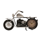 Black and silver metal motorbike mantel clock with kickstand, spoked front wheel, handlebars, seat, and round cream clock face as rear wheel, on white background.