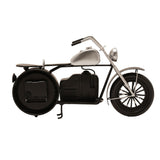 Motorbike-shaped metal mantel clock in black and silver, with the round clock face set as the rear wheel, silver fuel tank and spoked front wheel, on a plain white background.