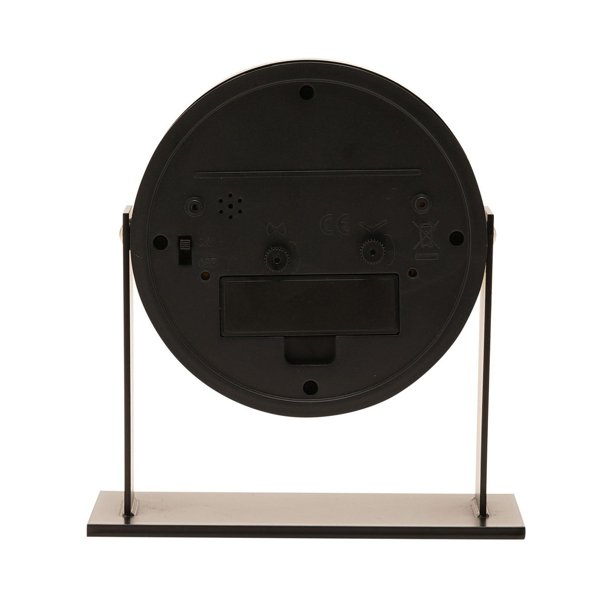 Rear view of the Round Adjustable Metal Alarm Clock 13.5cm in black, showing control switches, alarm and time-set dials, and battery compartment on a black metal stand.