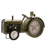 Green tractor mantel clock with Arabic numeral dial in the rear wheel, featuring a bonnet with exhaust stack, grille, steering wheel, seat, and front wheel, on a white background.