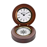 Round folding mantel clock in walnut-finish wood, open to show a white Roman numeral dial with gold-tone bezel above a compass rose set into the base, on a plain white background.