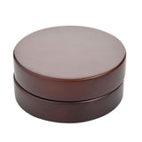 Closed walnut finish folding mantel clock with compass, shown as a round disc case on a plain white background.