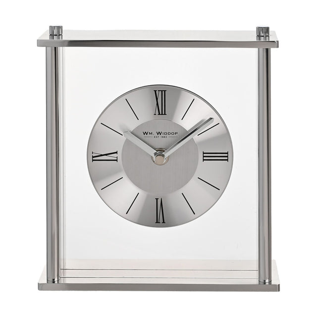 Square silver mantel clock with clear glass panels, four pillar supports, and a round two-tone dial featuring black Roman numerals, set against a plain white background.