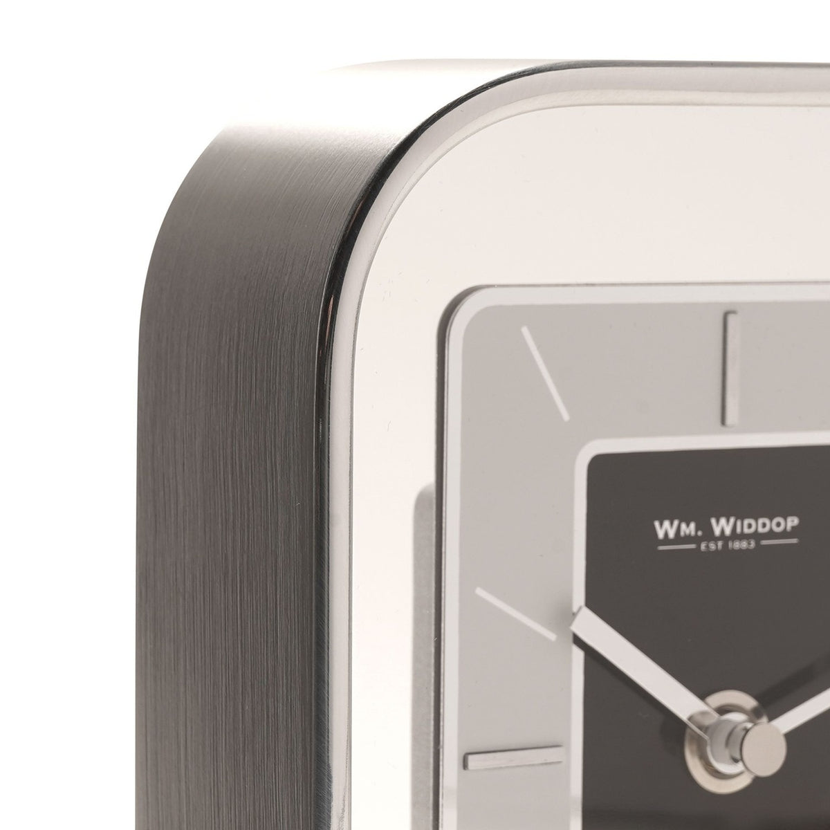 Close-up of the Arched Portrait Mantel Clock in silver metallic finish, showing the curved brushed edge and rectangular dial with black centre panel, silver-grey surround, and baton markers.