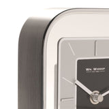 Close-up of the Arched Portrait Mantel Clock in silver metallic finish, showing the curved brushed edge and rectangular dial with black centre panel, silver-grey surround, and baton markers.