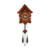 Pitched Roof Quartz Wooden Cuckoo Wall Clock in mahogany, with carved leaf details, black Roman numeral dial, and hanging pinecone-style pendulum weights on a plain white background.