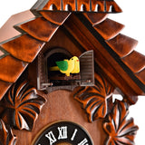 Close-up of the Pitched Roof Quartz Wooden Cuckoo Wall Clock in mahogany, showing layered shingle roof, carved leaves, open shutters with yellow bird, and black dial with Roman numerals.