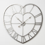 Open Heart Metal Wall Clock in silver finish with cut-out Roman numerals between double heart outlines and slim hands, shown on a plain white background.