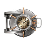 Riveted Safe Door Wall Clock in silver finish with copper-toned spoked wheel, hinge and loop handle, cream and gold dial with black numerals, on a plain white background.
