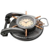 Riveted Safe Door Wall Clock in silver finish with copper-toned spokes, porthole bezel, cream and gold dial, hinge bracket and looped handle, shown on a white background.
