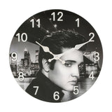 Round glass wall clock, 33cm, with a black and white portrait print of a man against a night city skyline and bridge, bold white Arabic numerals and white hands.