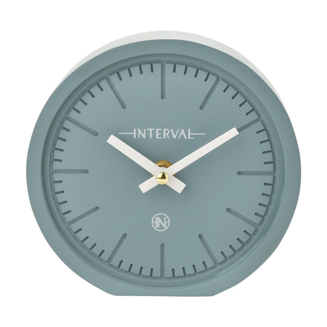 Round matt teal mantel clock, 15.4cm, with a numeral-free dial, baton hour markers, white hands and gold centre detail, set against a plain white background.