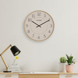 Round wall clock, 50.5cm, with beige and white dial, black numerals and hands, light wooden frame, shown above a desk with lamp and plants.