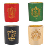Set of 4 round glass tealight candle holders in red, green, black and cream, each with a gold Hogwarts house crest and name scroll, on a white background.