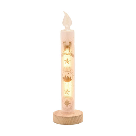 Harry Potter Hogwarts Yule Ball LED candle, 29.5cm white glass column with gold Hogwarts crest, star and castle skyline print, set on a round wooden base against a plain white background.
