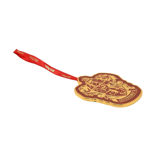 Harry Potter Gryffindor metal hanging decoration with gold crest and lion design on red epoxy ground, red ribbon loop, plain white background.