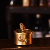 Harry Potter Hedwig round trinket box in brushed gold finish, with a detailed owl figure on the lift-off lid and "HEDWIG" raised on a front banner.