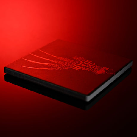 Square black stoneware coaster featuring Freddy's clawed hand in red lettering with "Never Sleep Again" text, shown at an angle under red lighting.