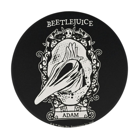 Round black ceramic coaster featuring Beetlejuice Adam in white, face stretched into a point within an ornate scrolled frame topped by a skull and striped creatures, "ADAM" labelled below.