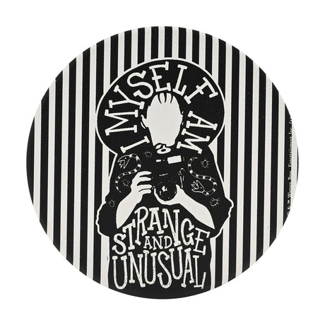 Round white ceramic coaster featuring a black Beetlejuice design of a silhouetted figure holding a camera, with "I Myself Am Strange and Unusual" lettering and a striped border, on a plain background.