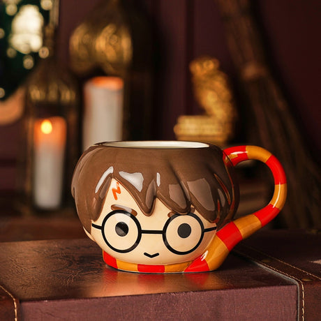 Harry Potter 3D stoneware mug shaped as his head with round glasses and lightning scar, brown hair, and a red-gold striped scarf forming the base and handle.