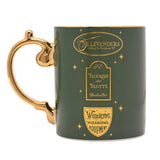 Green porcelain mug with gold handle, featuring Ollivanders, Flourish and Blotts, and Wiseacre's shopfront logos with star details, on a white background.