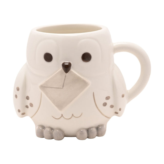 Harry Potter Hedwig Owl 3D stoneware mug in white, shaped like a snowy owl with dark eyes, a brown beak, grey speckled wings, and a letter held across the chest, set on a plain white background.