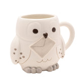 Harry Potter Hedwig Owl 3D stoneware mug in glossy white, sculpted as a snowy owl with dark eyes, a brown beak, a raised grey envelope and speckled wings, shown on a plain white background.