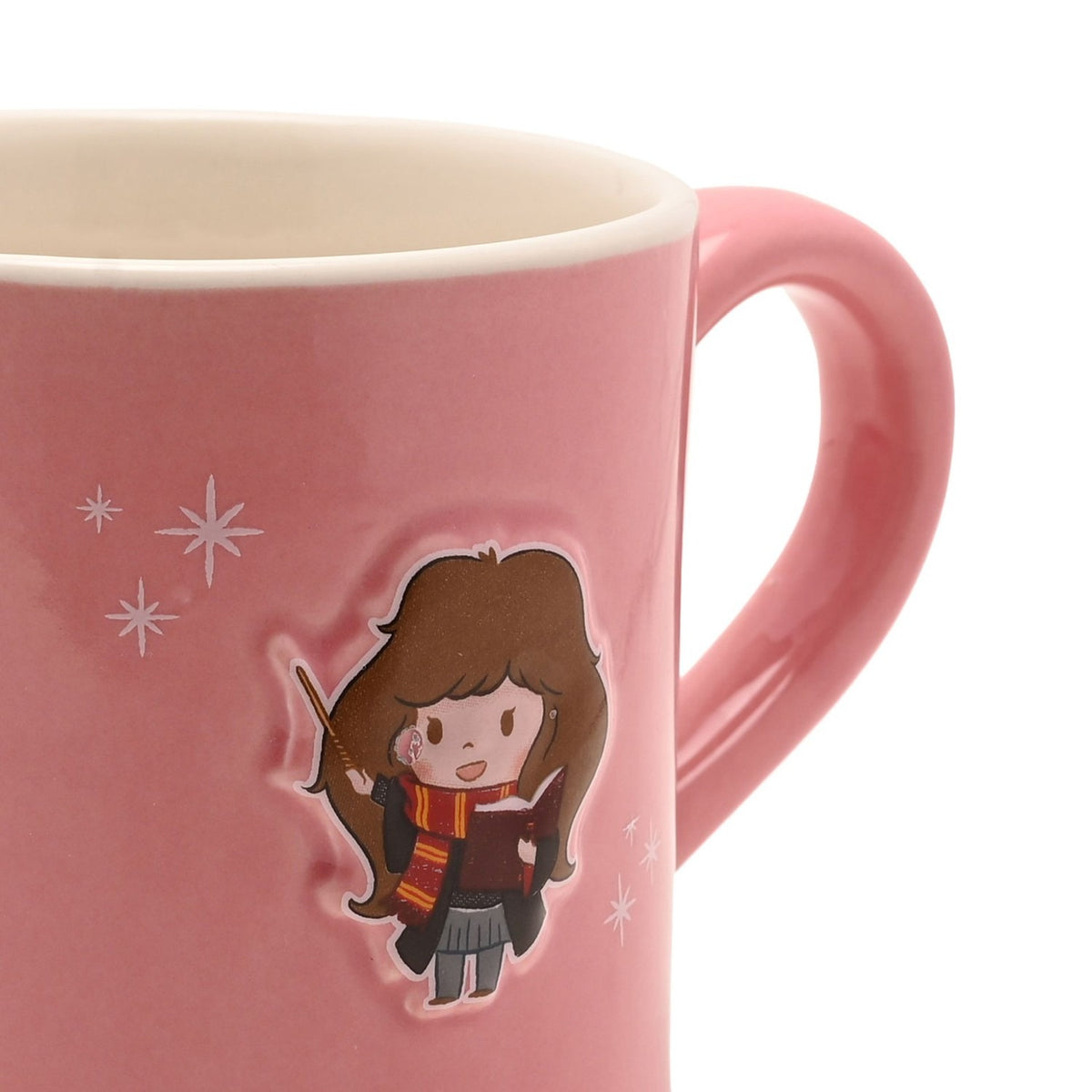 Close-up of a pink stoneware mug with a glossy pink handle, featuring an embossed cartoon Hermione holding a wand and book, with white sparkle details, on a plain white background.