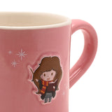 Close-up of a pink stoneware mug with a glossy pink handle, featuring an embossed cartoon Hermione holding a wand and book, with white sparkle details, on a plain white background.
