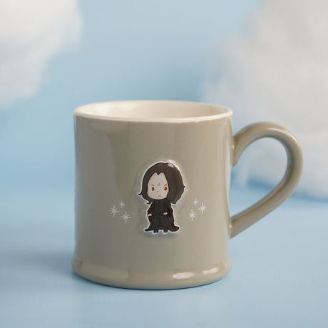Grey stoneware mug with a raised embossed Severus Snape figure in black robes and surrounding white sparkles, glossy finish, shown on a light blue background with soft cloud-like surroundings.