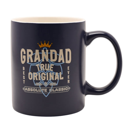 Blue stoneware mug with white interior, printed with "Grandad True Original Absolute Classic" in cream and pale blue lettering beneath a gold crown, shown on a white background.