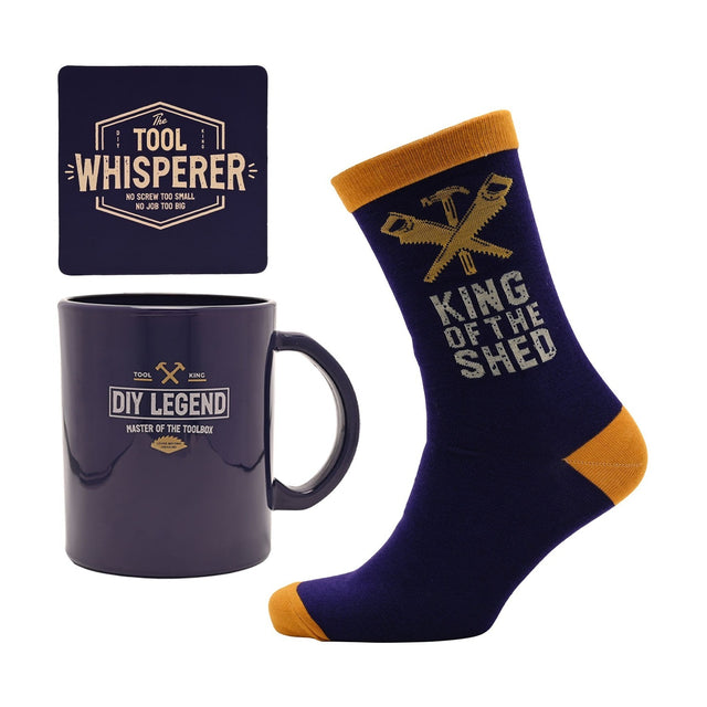 DIY Legend Mug and Cotton Socks set in blue with mustard cuffs, heel and toe, plus a matching square coaster reading "The Tool Whisperer", shown on a white background.